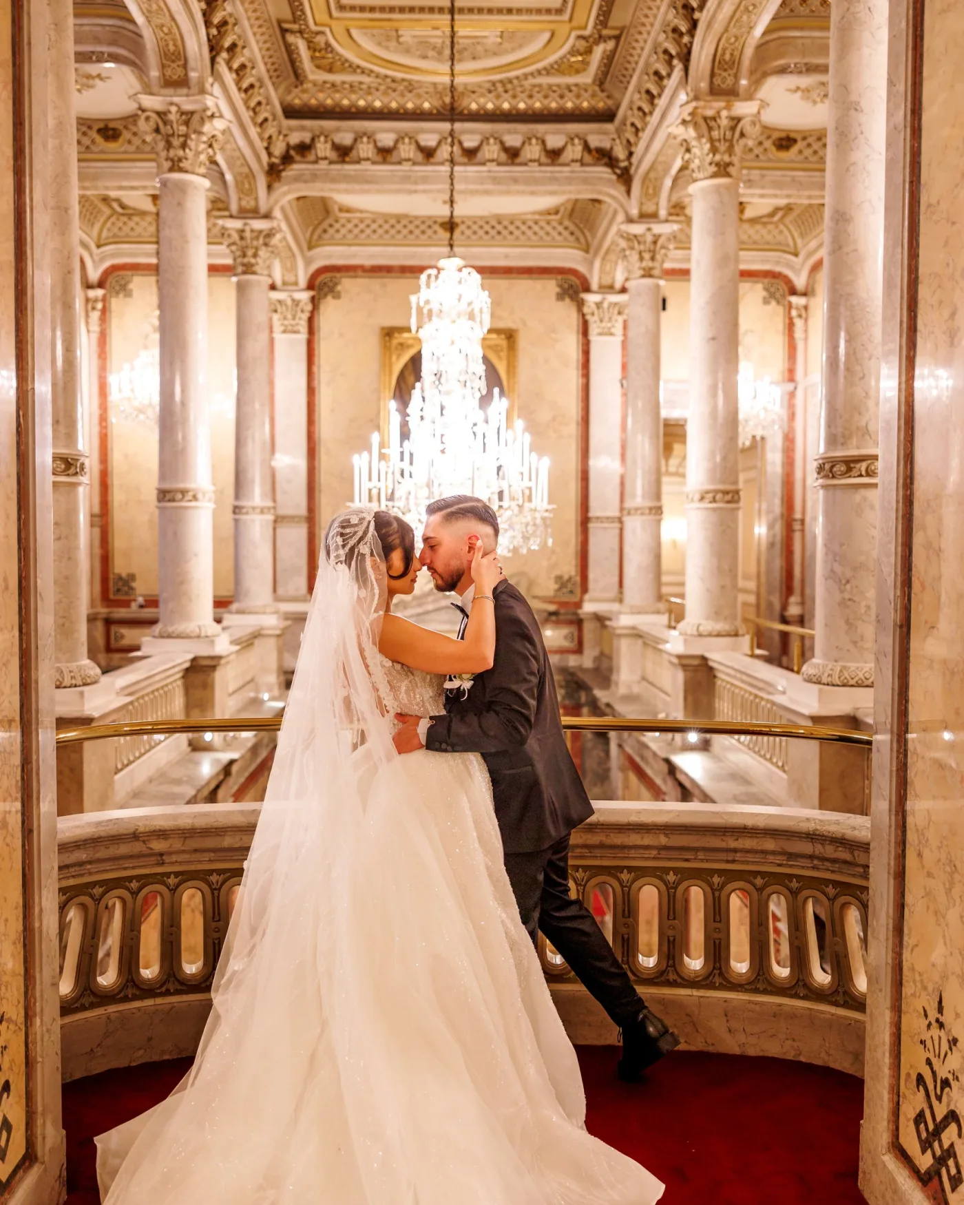 Couple embracing under a chandelier in a Viennese palace