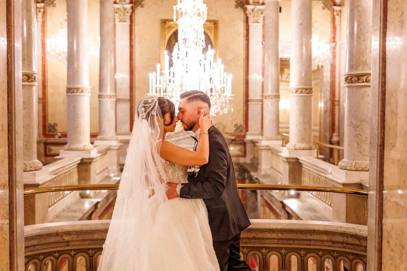 Couple embracing under a chandelier in a Viennese palace