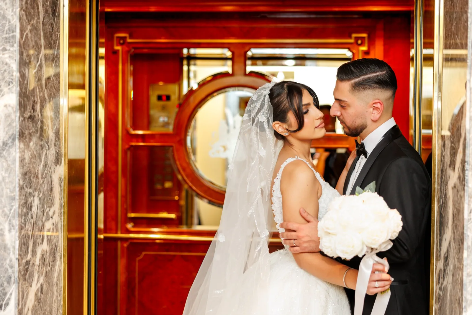 Wedding couple kissing at a historic Vienna entrance